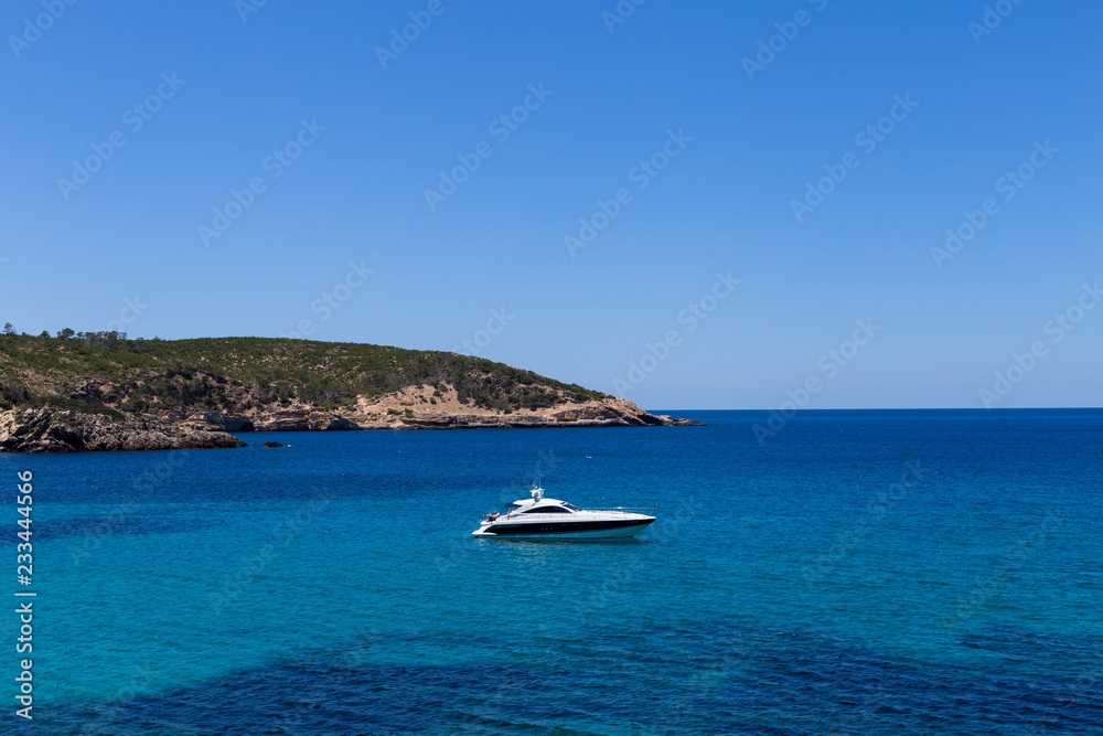 beautiful landscape in Ibiza of blue ocean in a sunny day with boats in the horizon. Summer and holidays concept.