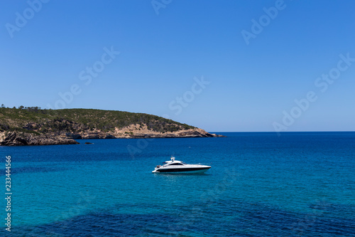 beautiful landscape in Ibiza of blue ocean in a sunny day with boats in the horizon. Summer and holidays concept. © Eva