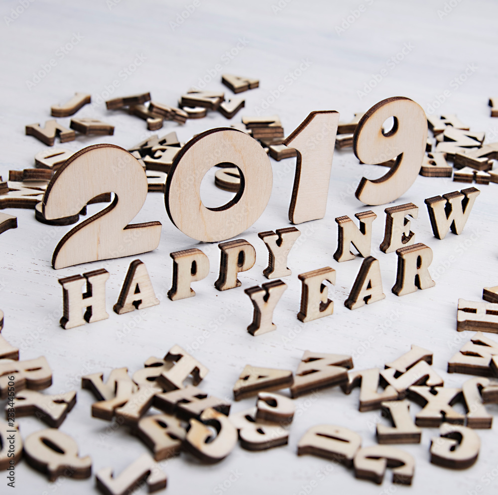 Congratulations with new 2019 year made of wooden letters on a light background Congratulations with new 2019 year made of wooden letters on a light background