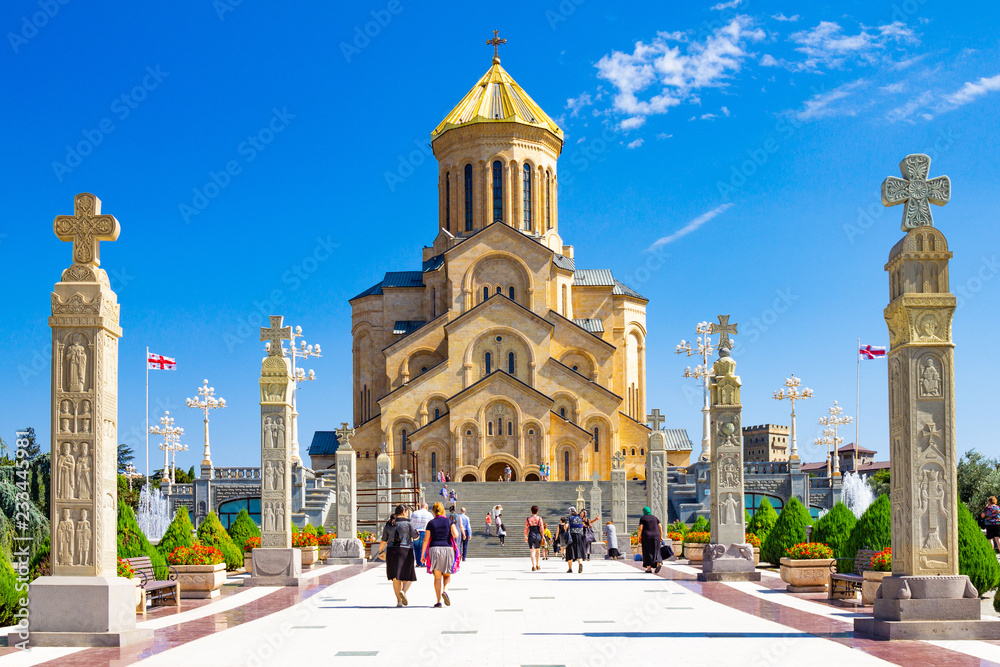 Main view with the stair case and cross pillars columns to Tbilisi Sameba Cathedral Tsminda Holy Trinity biggest church Orthodox in a sany day in Caucasus region. The main cathedral of the Georgian.