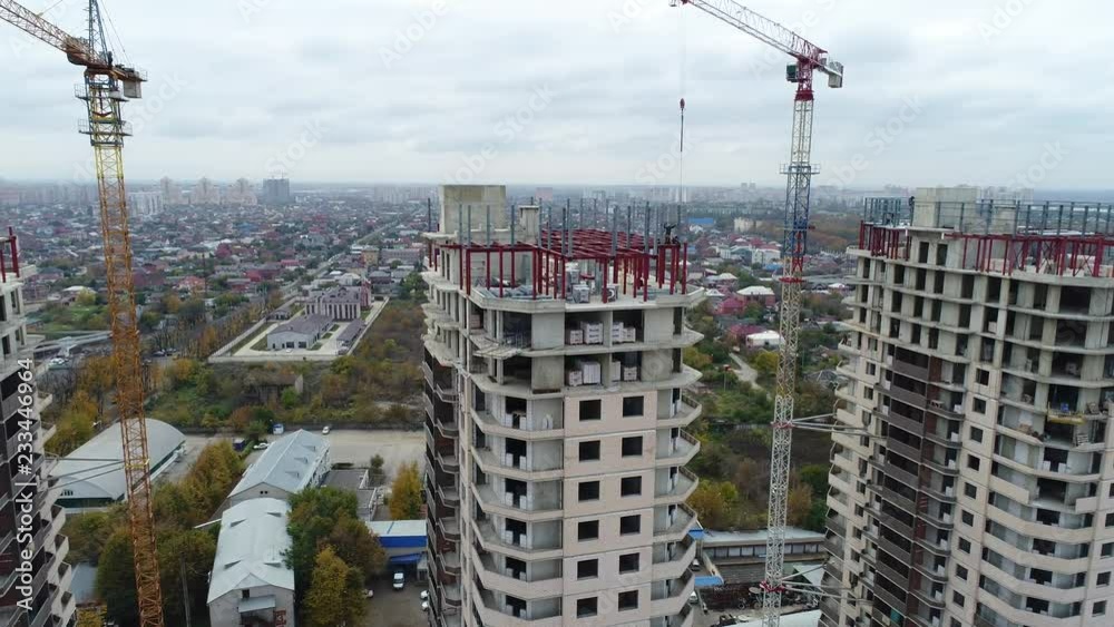 Aerial - construction of a tall building, construction crane. Aerial - construction of a tall building, construction crane.