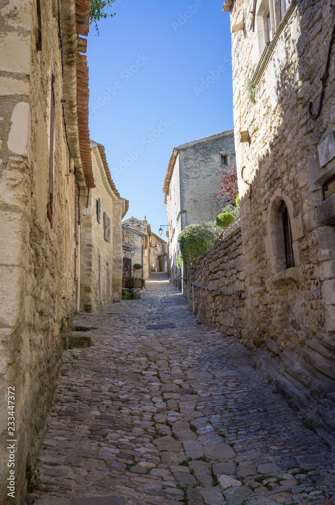 Authentic cobblestone street in Lacoste village, Vaucluse, France