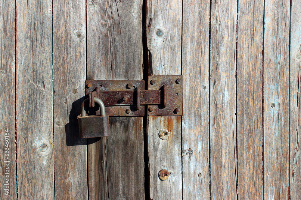 Old Wooden Fence. Close Up Shot Of Wooden Wall. Iron Lock On Wooden Door. Old Wooden Fence. Close Up Shot Of Wooden Wall. Iron Lock On Wooden Door.