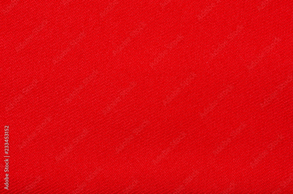 Red fabric material texture on blur background Red fabric material texture on blur background