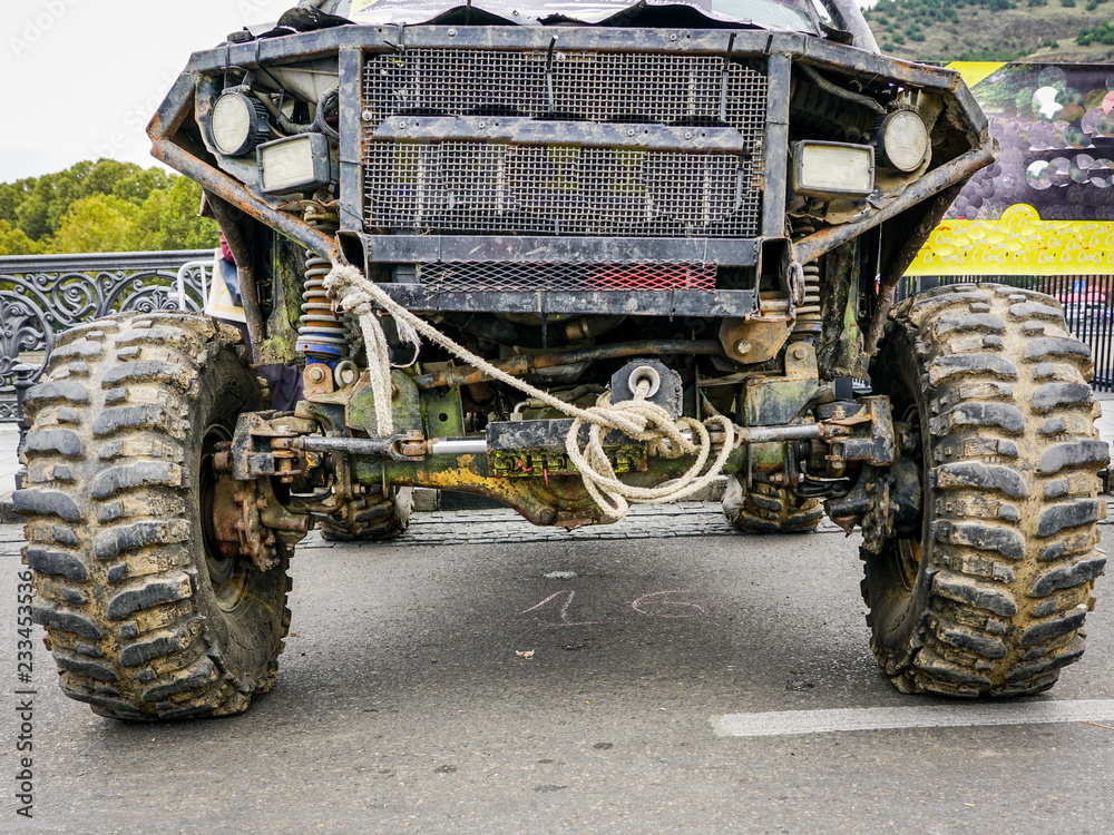 Fototapeta premium closeup front view of dirty black off-road car