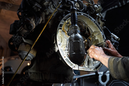 Mechanic repairman working and repair car engine in car service 