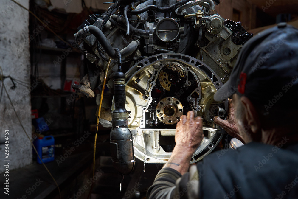 Mechanic repairman working and repair car engine in car service 