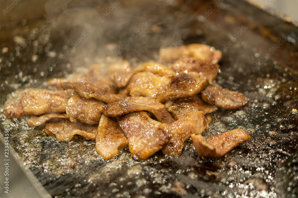 Japanese chef cooking wagyu beef with sauce in the kitchen to serve gourmet restaurant meal, delicious grill meat