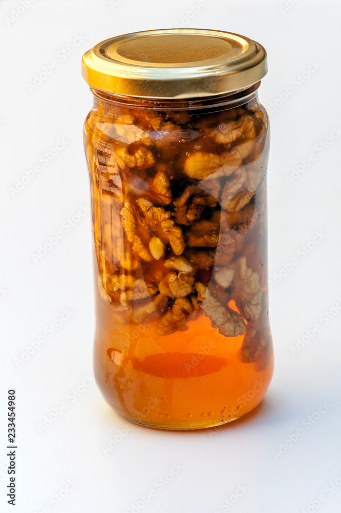 Honey with nuts surrounded by white background Honey with nuts surrounded by white background