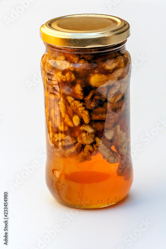 Honey with nuts surrounded by white background
