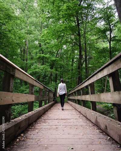 Girl walking over bridge