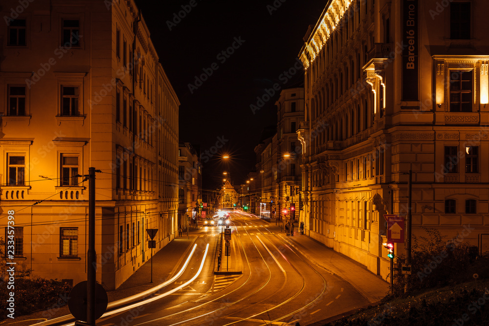 Tram stop Šilingrovo náměstí in Brno passing through public transport during the night long street full of colors and lights Tram stop Šilingrovo náměstí in Brno passing through public transport during the night long street full of colors and lights