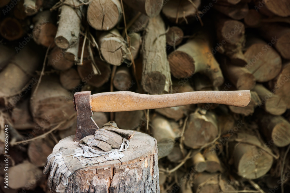 Ax stuck in a large wooden stump after work on the preparation of firewood. Ax stuck in a large wooden stump after work on the preparation of firewood.