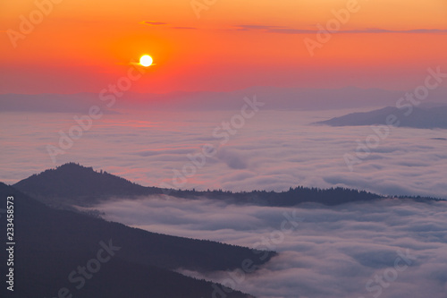 Golden hour in the mountains. Sunrise over mist-covered valley © Serhii Moiseiev