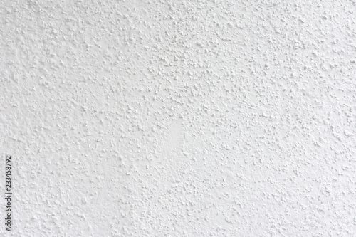 White gray painted cement wall, uneven concrete surface