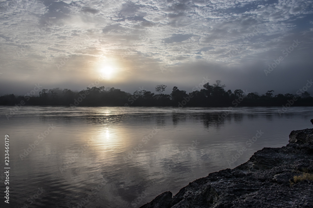 Sunrise over the Tambopata River in the Amazonas Region near Puerto Maldonado, Peru Sunrise over the Tambopata River in the Amazonas Region near Puerto Maldonado, Peru