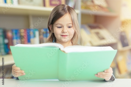 Portrait of young cute girl with book