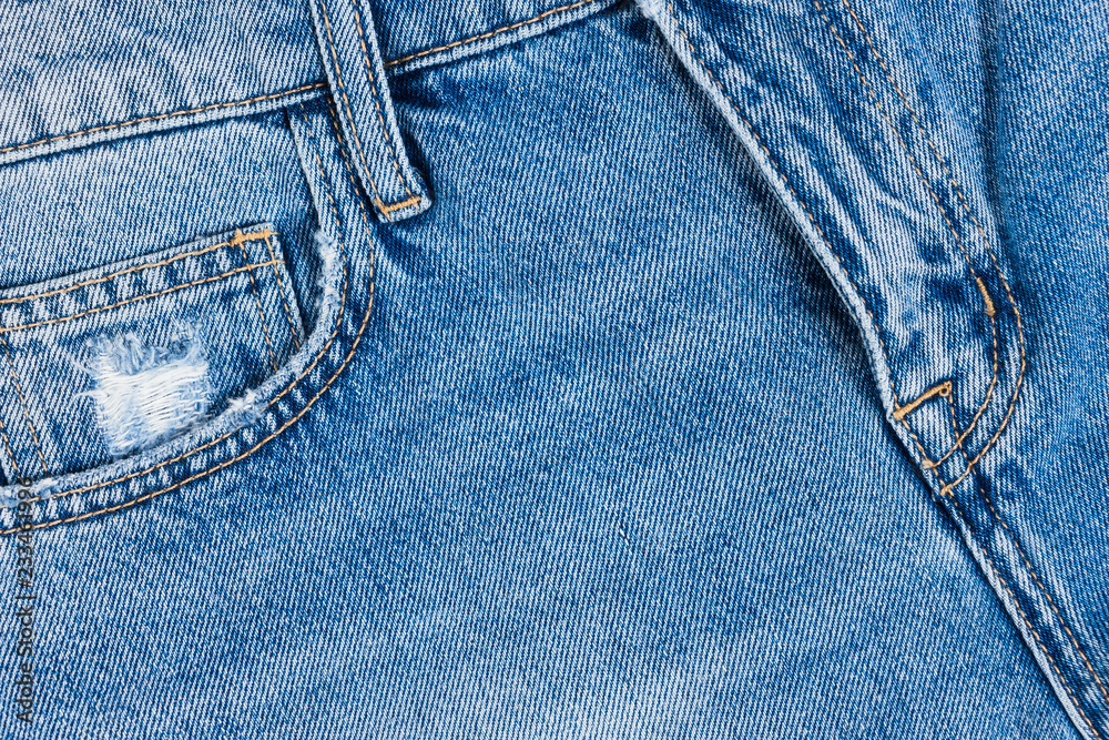 Blue jeans cotton texture. Close up view on fifth pocket and fly. Blue jeans cotton texture. Close up view on fifth pocket and fly.