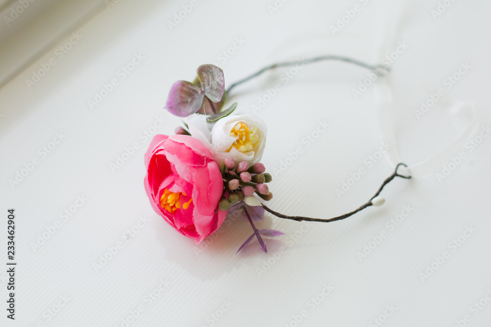 the wreath on his head. wreath of pink and white flowers. a wreath on the woman and child. the decoration on the head. Hoop of flowers. hair decoration