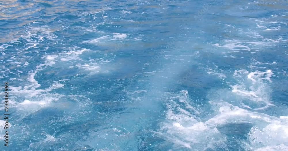 On board side view of a yacht navigating on blue sea vawes. Luxury yacht floats on blue sea waves. Sailing in the wind through the waves On board side view of a yacht navigating on blue sea vawes. Luxury yacht floats on blue sea waves. Sailing in the wind through the waves