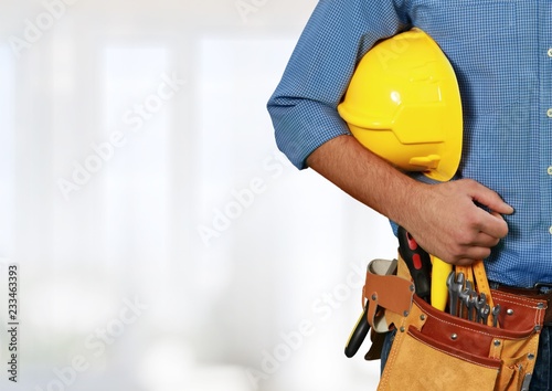 Worker with a tool belt. Isolated over white background.