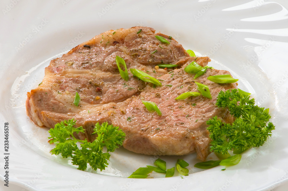 Стейк из свинины на тарелке Pork steak on a plate Стейк из свинины на тарелке Pork steak on a plate