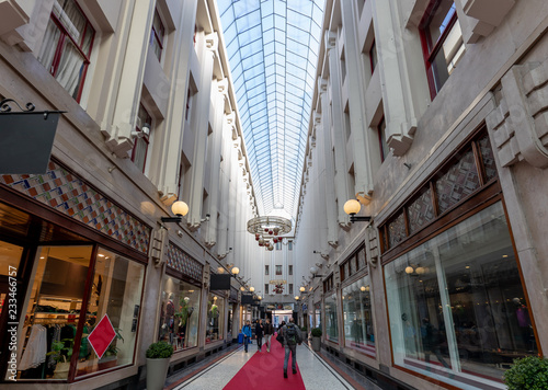 People doing their holiday shopping in a fancy indoor shopping passage street in autumn