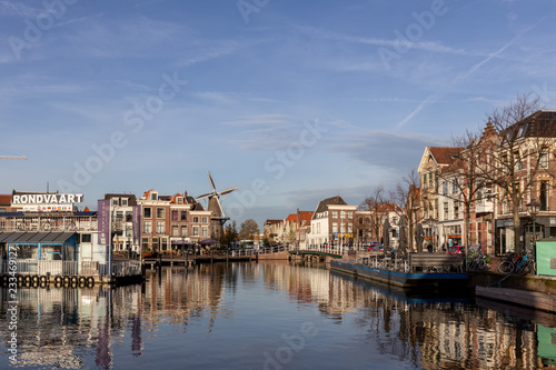 Picturesque medieval city of Leiden in the Netherlands with old historic cityscape on a sunny afternoon with a Windmill in the background