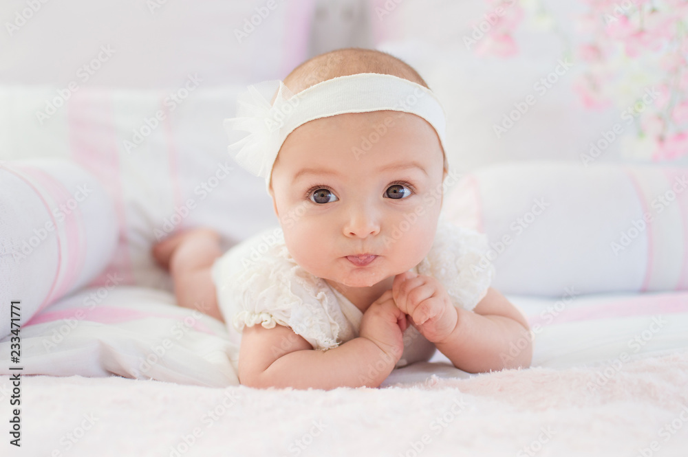Portrait of a crawling baby on a bed in his room. The concept of a happy child. Diapers. Portrait of a crawling baby on a bed in his room. The concept of a happy child. Diapers.