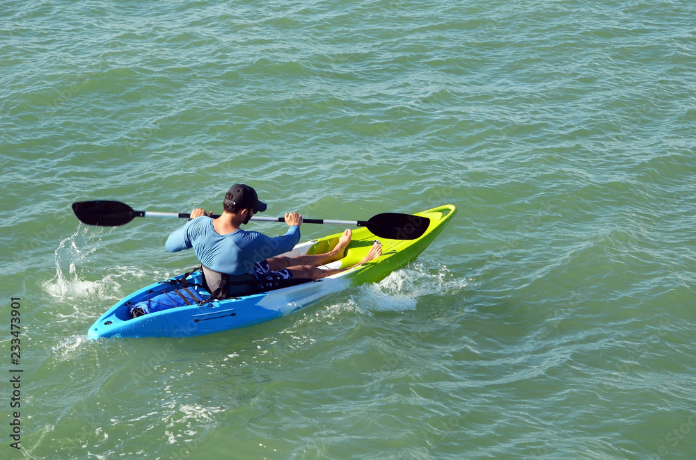 Man rowing a single place kayak on the Florida Intra-Coastal Waterway near Miami Beach.
