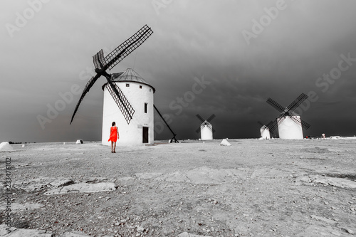 Mujer mirando los molinos de don Quijote, Campo de Criptana, La Mancha, España photo