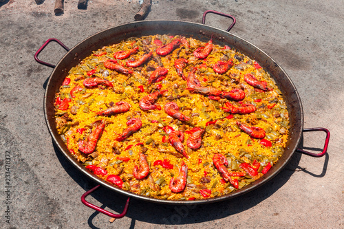 Seafood Paella. The national Spanish dish of paella in a large skillet is cooked on an open fire, at the stake.