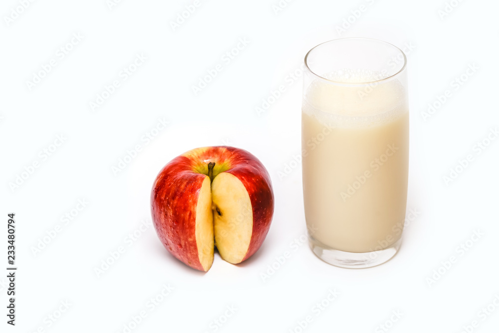 Glass of apple juice next to a tasty apple. Glass of apple juice next to a tasty apple.