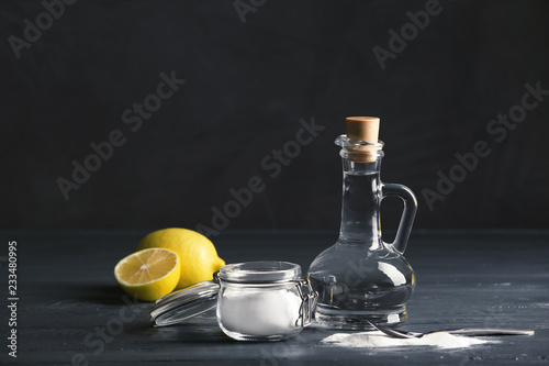 Composition with vinegar, lemons and baking soda on table