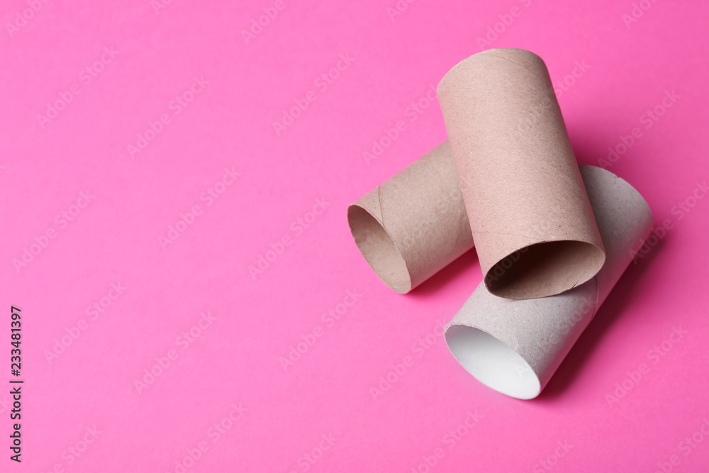 Empty toilet paper rolls and space for text on color background Empty toilet paper rolls and space for text on color background
