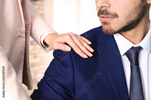 Fotografie Woman molesting her male colleague in office, closeup