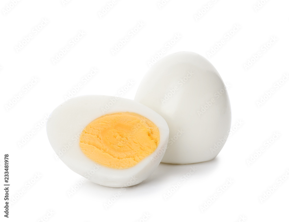 Sliced and whole hard boiled eggs on white background