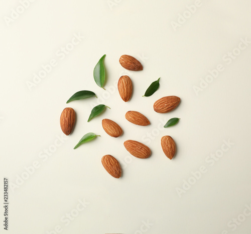 Foto Composition with organic almond nuts on light background, top view