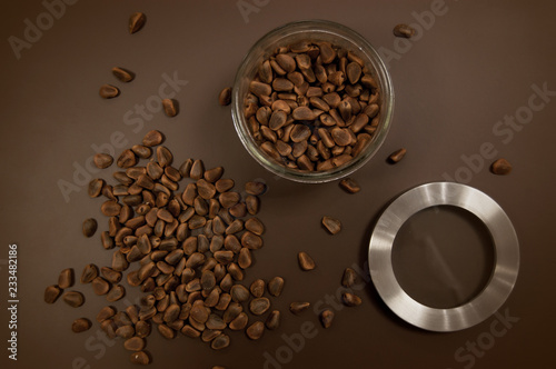 Crude pine nuts on brown background top view. Organic and healthy food.