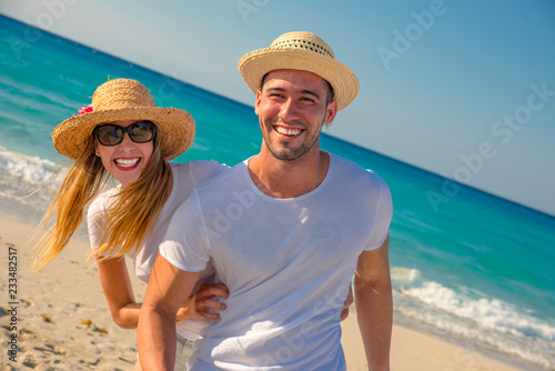 Tableau sur toile pareja de jovenes bellos en una playa del caribe riendo y disfrutando