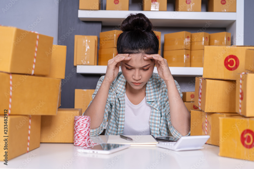 stressed young entrepreneur woman and courier parcel box at home office stressed young entrepreneur woman and courier parcel box at home office