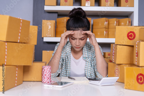 stressed young entrepreneur woman and courier parcel box at home office © geargodz