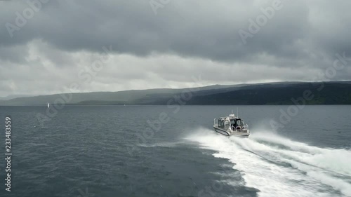 Cinematic aerial tracking shot of a speedboat in Scotland photo