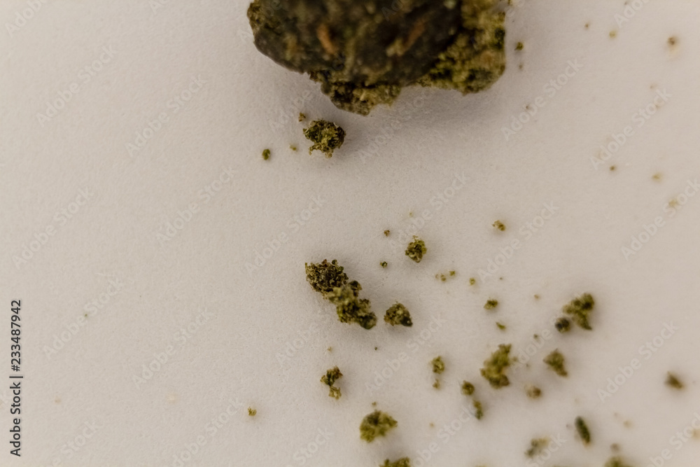 Ball of marijuana sift crumbling on a white background.