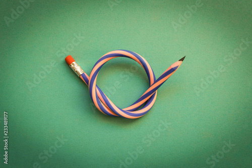 Flexible pencil . Isolated on light background. Bending pencil