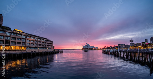 Hotel, pier and Opera House on Sydney Harbour at dawn