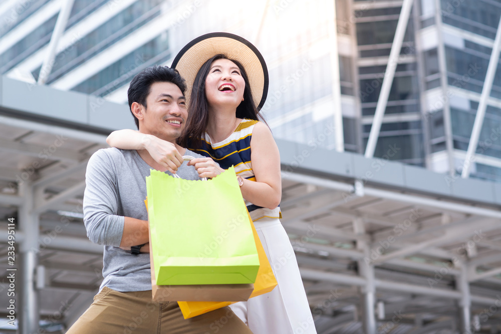 Young asian couple tourists city walk and shopping together in vacation Young asian couple tourists city walk and shopping together in vacation