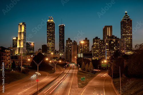 Car traffic flowing towards city skyline, after sunset. Summer evening in Atlanta, USA.