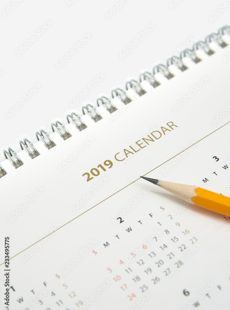 Desk calendar and yellow pencil on white background. Desk calendar and yellow pencil on white background.