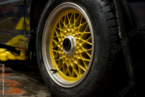 Legendary alloy net sport rims on beautiful wheels in polished and gold color © Aleksander